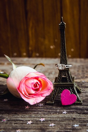 Declaration of love, the rose with a ring on a wooden board.の写真素材