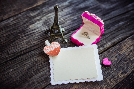 Declaration of love, the rose with a ring on a wooden board.の写真素材