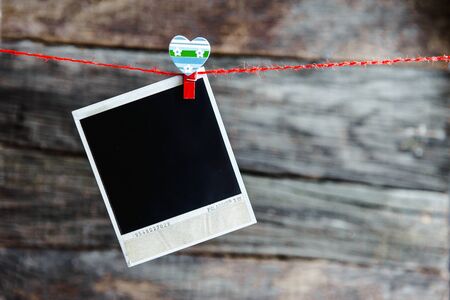 one photo frames and heart for valentine's day hanging on rope withの写真素材