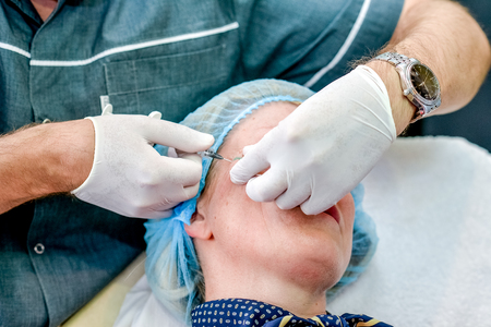 Senior woman getting skin care injection. Senior woman getting skin care injectionの写真素材