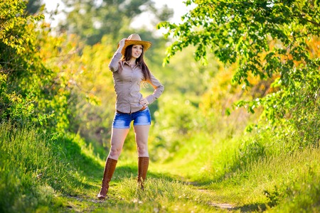 young beautiful girl in a cowboy hat, country styleの写真素材