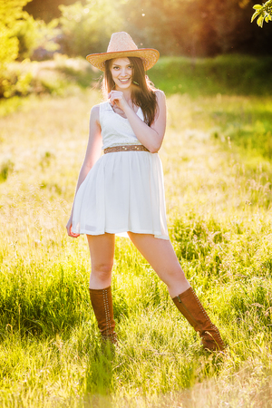 young beautiful girl in a cowboy hat, country styleの写真素材