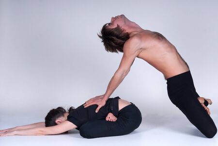 Young healthy couple in yoga position. Studioの写真素材