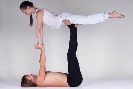 Young healthy couple in yoga position, Man and woman. Studioの写真素材