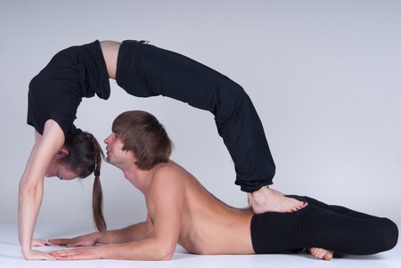 Young healthy couple in yoga position, Man and woman. Studioの写真素材