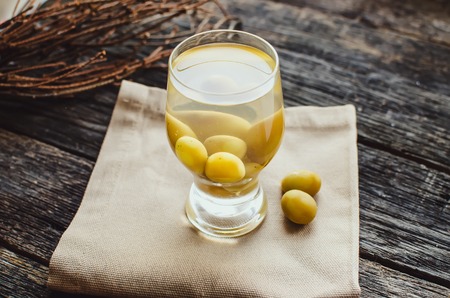 compote of grapes in a glass worth on a wooden tableの写真素材