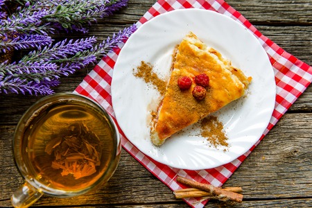 delicious pie with cottage cheese with raspberry, cup of green teaの写真素材