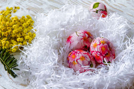 Decorated with painted Easter eggs and flowers on a light background. Decoupageの写真素材