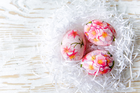 Decorated with painted Easter eggs and flowers on a light background. Decoupageの写真素材