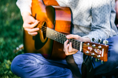 Man playing acoustic guitar close up outdoors. Man playing acoustic guitar close up outdoors