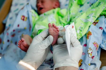 doctor takes a blood test in newborns. Extract from the hospitalの写真素材