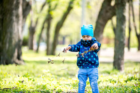 Boy blowing bubbles at the park. black boyの写真素材