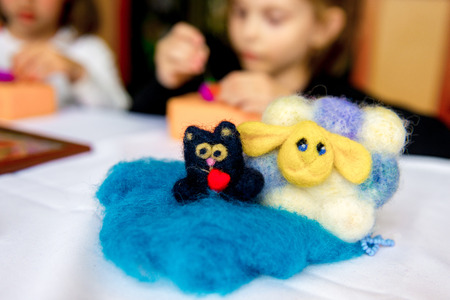 Manufacturing process from wool soft toys. Felting activity. The child makes a toy made of woolの写真素材