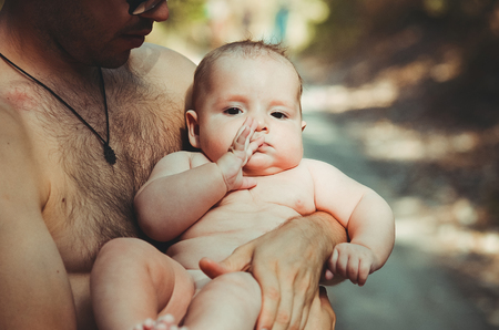 child sits on dad's shoulder and smiling. Summerの写真素材