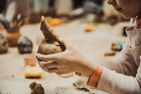 children's hands sculpts clay crafts pottery schoolの写真素材