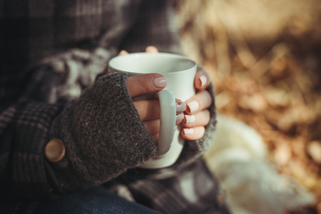 Young woman in hat with tablet pc at the beach. girl sitting on a deck chair with the tabletの写真素材