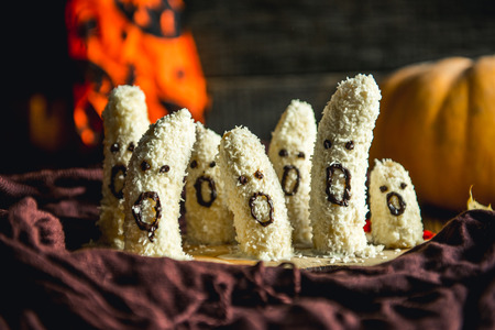 Homemade halloween scary banana ghosts monsters with chocolate faces. funny dessert recipe for party...
