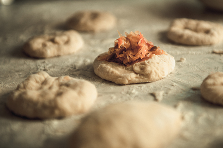 homemade cakes of the dough in the women's hands. The process of making pie dough by handの写真素材