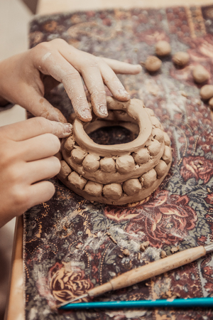 children's hands sculpts clay crafts pottery schoolの写真素材
