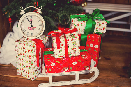 Photo of luxury gift boxes under Christmas tree, New Year home decorations, wrapping of Santa...