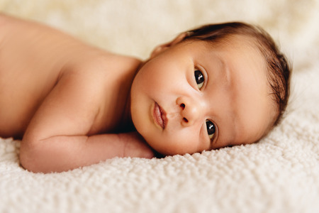 Newborn baby boy lying in a crib. Child preparing to sleepの写真素材