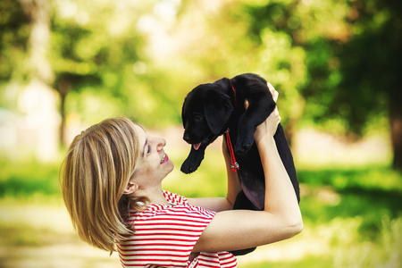 Girl with labrador puppyの写真素材