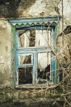 View of an old abandoned log house, finished with a plaster in a village.の写真素材
