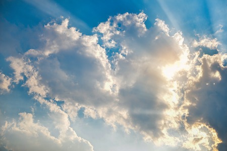 Big white cloud hiding the sunの写真素材