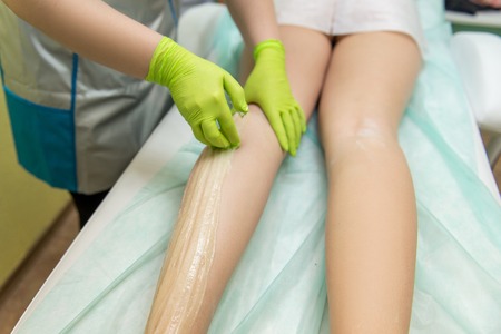 Sugaring Sugar waxing feet in the beauty salon.の写真素材