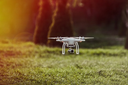 The launch of the quadrocopter in the park in the summer