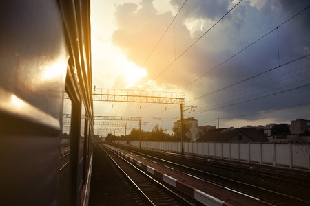 Railway station against the sunny sky. Railway tourism, railway tourism. View from the car. Rural...