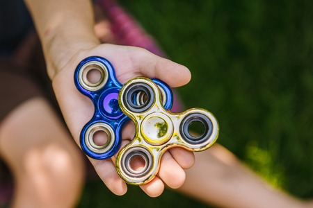 Two spinner in the childs handsの写真素材