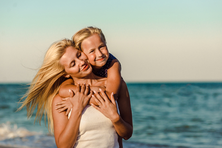 Happy family during summer vacation on white beachの写真素材