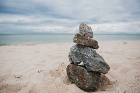 A stone pyramid laid out on the shore . Photo toned.Balance, peace and harmony