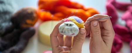 Manufacturing process from wool soft toys. Felting activity