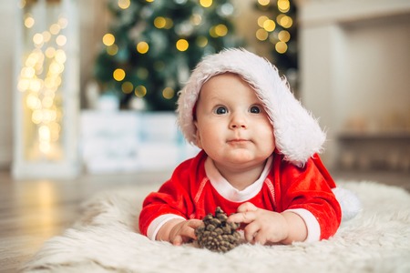 Christmas morning, baby dressed as Santa Clausの写真素材