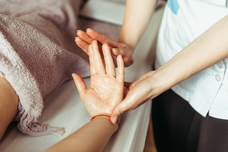 physical therapist massaging handsの写真素材