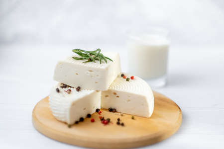 Homemade Adyghe cheese on a plate with spicesの写真素材