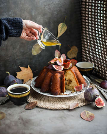 Cupcake with fresh figs. Sponge cake on a wooden stand. Autumn sweet food.の写真素材