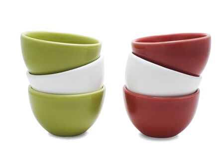 Two piles of stacked red, green white cups isolated on white.の写真素材