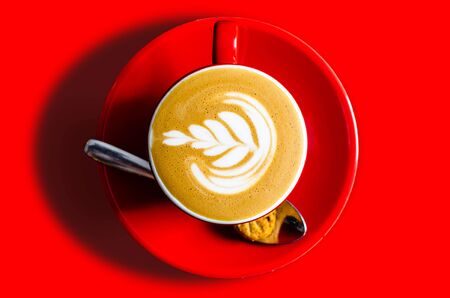 red cup of coffee-art latteの写真素材