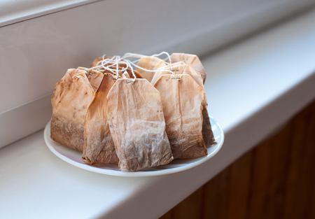 Used tea bags drying on the window sillの写真素材