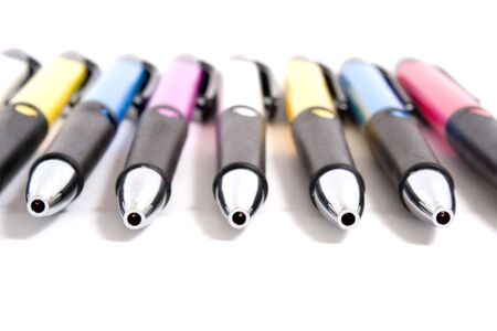 colorful pens in row isolated on whiteの写真素材