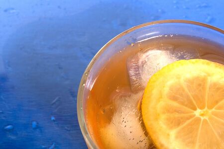a cup of tea with lemon and iceの写真素材