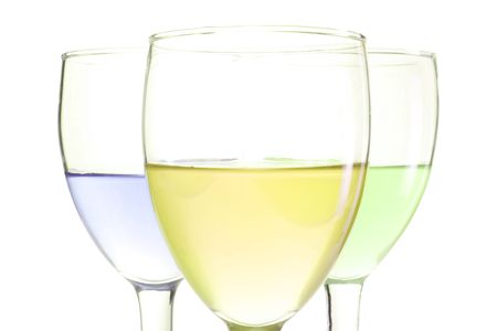 three glasses with green blue and yellow drinksの写真素材