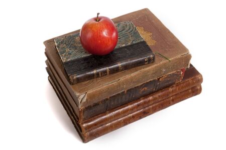 stack of retro books and apple isolated on whiteの写真素材