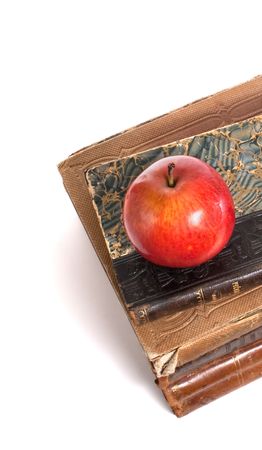 stack of retro books and apple isolated on whiteの写真素材