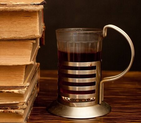 stack of books and glass of tea