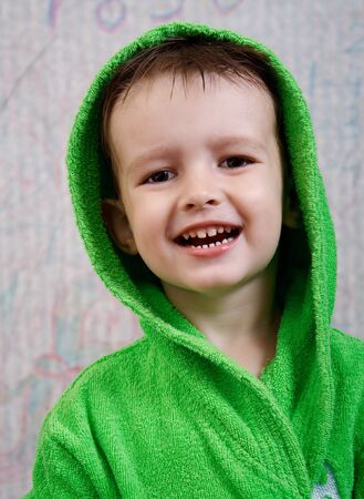 happy child in green dressing gownの写真素材