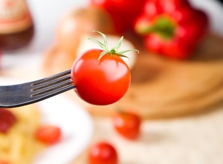 fork with cherry tomato on itの写真素材